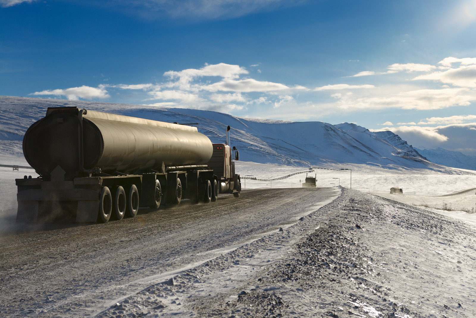 Trucks driving along the Dalton Highway in Alaska